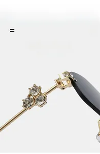 Detail of luxury gold metal hinges with sparkling rhinestones on rimless sunglasses