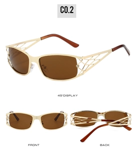 Detail view of gold hollow metal frame Y2K sunglasses with brown lenses and rhinestones
