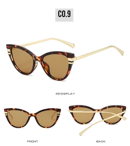 Detail of tortoiseshell cat-eye sunglasses with golden metal temples and brown lenses