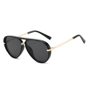 Classic oversized aviator sunglasses with black frames and gold metal temples on white