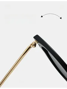 Detail of durable gold metal hinge on vintage black sunglasses with a sleek finish