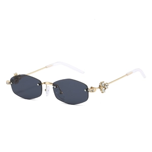 Rimless diamond sunglasses with hexagonal grey lenses and gold metal temples for women