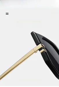 Close-up of premium metal hinge structure and slim gold temple on oversized square sunglasses