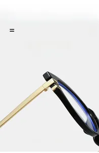 Detailed close-up of the durable metal hinge connecting black frame and gold temples