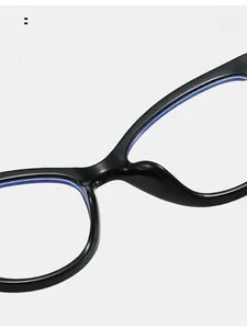Detail of integrated comfortable nose pads on black cat-eye glasses with blue accents