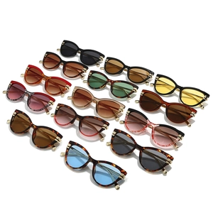 Collection of retro cat-eye sunglasses in various colors on a white background