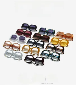 Multiple colorful geometric hexagonal sunglasses arranged in a stylish grid display