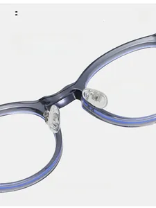 Detail of adjustable transparent silicone nose pads on oval TR frames for comfort