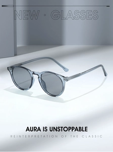 Detail view of stylish light blue TR90 sunglasses with transparent frames on white surface