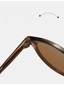 Detail of durable textured metal hinges on stylish amber TR90 frame sunglasses