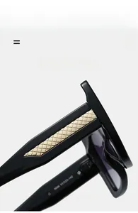Close-up of black sunglasses with gold quilted texture metal plate and model number