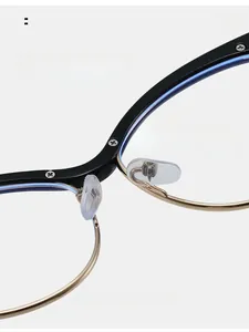 Detail of comfortable nose pads on black and gold cat-eye glasses for long-term wear