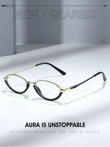 Close-up of retro oval glasses frame in black and gold finish with metallic temples