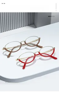 Detailed view of oval half-frame glasses in brown and red with gold metal temples
