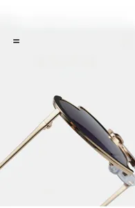 Detalle de la montura metálica dorada de gafas corazón con bisagras y plaquetas