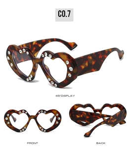 Detailed views of heart-shaped sunglasses with tortoise frame and rhinestone embellishments