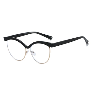 Cat eye blue light blocking glasses with black wavy frames and gold metal accents