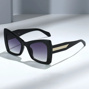 Chic black cat-eye sunglasses with purple gradient lenses and gold woven metal detail