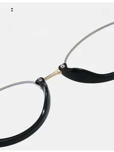 Detail of ergonomic integrated nose pads on black and gold metal eyeglass frames