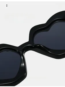 Detail view of heart-shaped sunglasses featuring integrated comfortable nose pads and sleek frame
