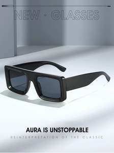 Detail view of bold black square sunglasses with wide temples on a modern geometric background