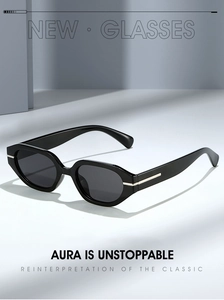 Detail of vintage black oval sunglasses with thick frames and golden hinge accents