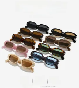 Detail view of colorful geometric oval sunglasses showing metal temple accents and various frames
