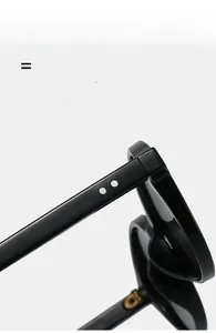 Detail of glossy black sunglasses frame featuring silver rivets and lightweight flexible temple
