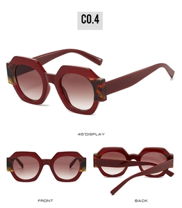 Detail view of hexagonal dark red sunglasses with tortoiseshell accents and gradient lenses