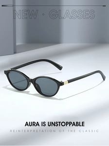 Detail of oval black sunglasses with gold diamond-shaped hardware on the temple