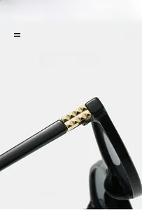 Detail of sunglasses hinge with gold pyramid stud and lightweight elastic material