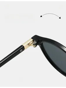 Detail view of durable golden metal hinges on elegant oval black frame sunglasses