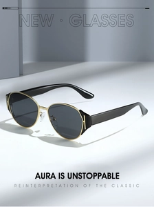 Detail of retro cat-eye sunglasses with gold metal stripe accents on black temples