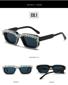 Detail view of square black sunglasses with sparkling rhinestones and dark lenses