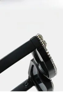 Close-up of sparkling crystals on the black square frame of these retro sunglasses