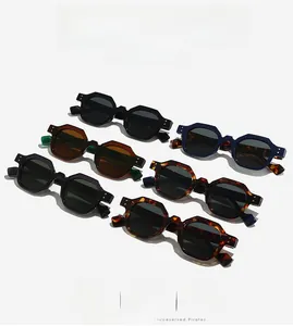 Collection of retro polygon sunglasses in multiple colors with rivet decor on white background
