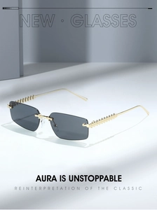 Detailed macro of gold metal temple with embossed patterns on rimless sunglasses