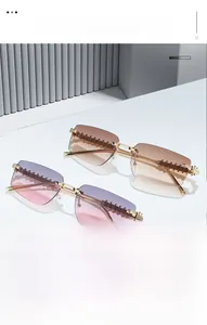 Detailed close-up of rimless gradient sunglasses with golden serrated metal temples