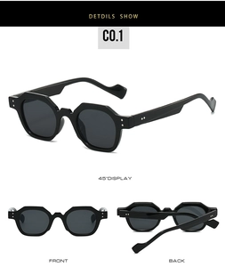 Detail view of black geometric sunglasses with silver rivets and grey lenses