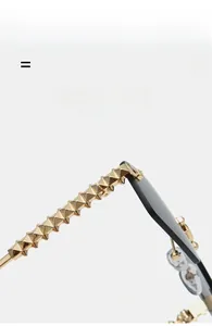 Detail view of gold metal temples with pyramid stud textures on square rimless sunglasses
