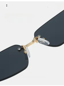 Close-up of comfortable silicone nose pads and golden metal bridge on rimless sunglasses