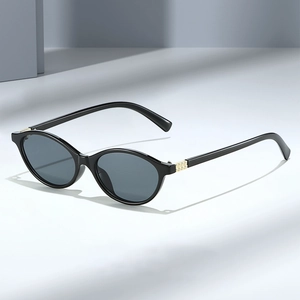 Fashionable oval sunglasses with black frames and gold-accented hinges for women
