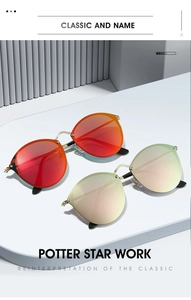 Detail of round metal sunglasses with vibrant red-orange and gold reflective lenses