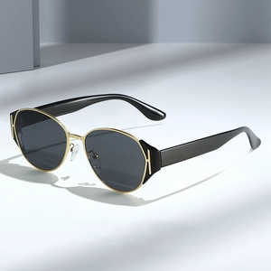 Chic cat-eye sunglasses with black lenses and gold H-logo detail on frames