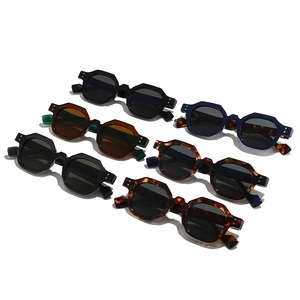 Retro polygon sunglasses with metal rivets in various colors on a white background