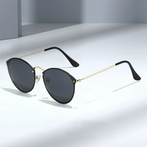Vintage round frame sunglasses with gold metal temples and dark UV protection lenses