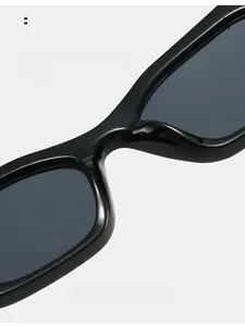 Detailed macro view of the integrated nose pads on glossy black rectangular sunglasses