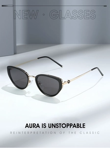 Detail of retro cat-eye sunglasses with sleek black frames and gold metallic temples
