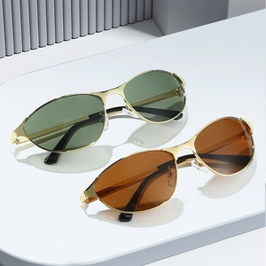 Vintage oval cat eye sunglasses with gold metal frames and green or brown lenses
