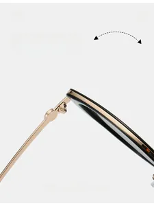 Detail of durable gold metal hinge on black cat-eye sunglasses with fashion texture